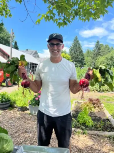Jay holding freshly harvested beets at Thunder Gardens